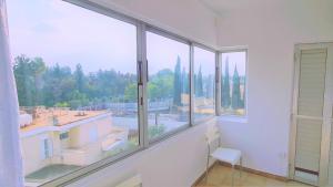 a room with windows with a view of a building at STAY Virtuoso Apartment Nicosia in Nicosia