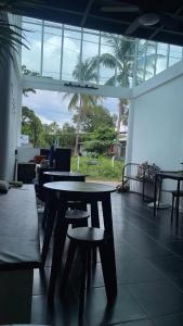 a room with tables and chairs in a building at MOOK BOONCHU HOTEL in Koh Mook