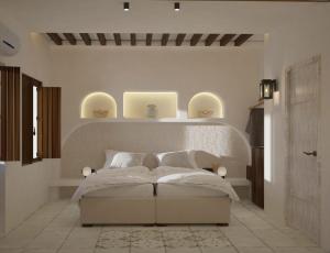 a bedroom with a bed with three lights on the wall at Chez Sophie in Kamari