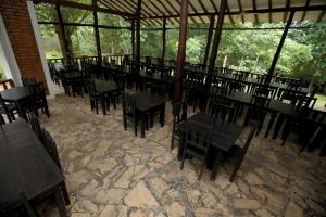 a restaurant with tables and chairs in a pavilion at The Mastodon Valley Safari Resort in Udawalawe