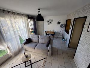 a living room with a couch and a table at Studio sur les rives d'allier in Moulins