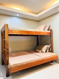 two bunk beds in the corner of a room at Kâyumanggi Studio in El Nido