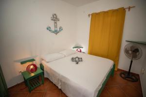 Appartamento LULA. Stella Maris Exclusive tesisinde bir odada yatak veya yataklar