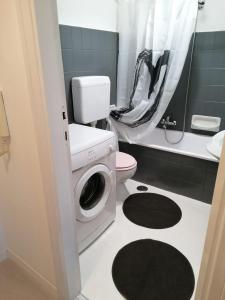 uma casa de banho com uma máquina de lavar roupa e um WC em Coccinella em Montesilvano