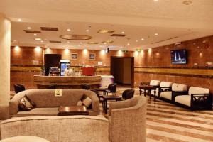 a salon with couches and chairs in a lobby at Al Andalus Palace 1 Hotel in Al Madinah