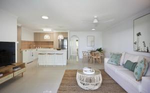 a living room with a couch and a table at Main Beach Coastal Apartment in Gold Coast