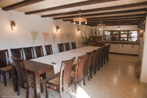 duża jadalnia z długim stołem i krzesłami w obiekcie Biertan 48 Guesthouse w mieście Biertan