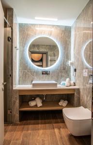 a bathroom with a sink and a mirror at Thalassa Apart Hotel in Alexandroupoli