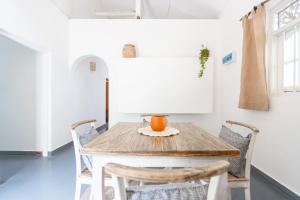 a dining room with a wooden table and chairs at Coconut Cottage - Hiriketiya Beach in Hiriketiya +32 photos