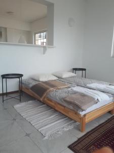 uma cama com uma estrutura de madeira num quarto em Athens The View em Atenas