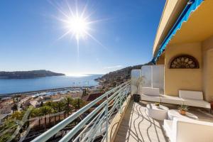a balcony of a building with a view of the ocean at Luxury Top Floor Sea View Apartment in Villefranche sur Mer in Villefranche-sur-Mer