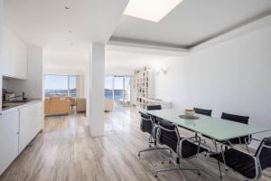 a kitchen and dining room with a table and chairs at Luxury Top Floor Sea View Apartment in Villefranche sur Mer in Villefranche-sur-Mer
