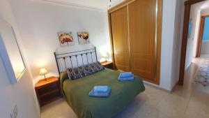 Łóżko lub łóżka w pokoju w obiekcie Rico Apartaments Ricosol