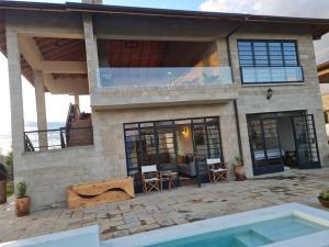 a house with a pool in front of it at The Landing Cottages in Nanyuki