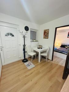 a room with a white door and a table and chairs at Apartment In Time in Sesvete