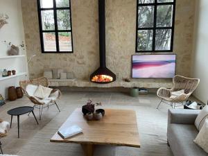 a living room with a couch and a fire place at L'escapade dans le ciel in Tourtour