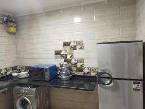 a kitchen with a counter top with a refrigerator at سيتى سكوير سيدى جابر عالبحر in Alexandria