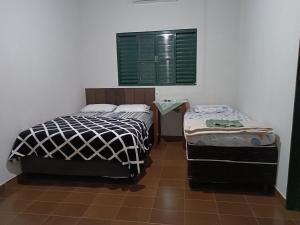 Ένα ή περισσότερα κρεβάτια σε δωμάτιο στο HOTEL RECANTO DOS BURITIS