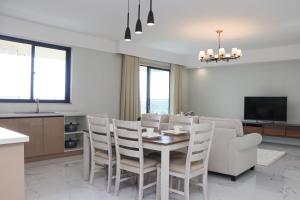 a kitchen and dining room with a table and chairs at 3bedroom apartment with ensuite bathrooms and Park views, conveniently located near JKIA and SGR in Nairobi