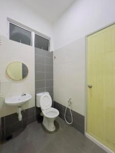 a bathroom with a toilet and a sink at NOOR Homestay Paddy View in Kangar +7 photos