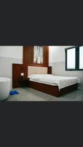 - une chambre avec un lit, un lavabo et une baignoire dans l'établissement Tulip Hotel, à Hô-Chi-Minh-Ville
