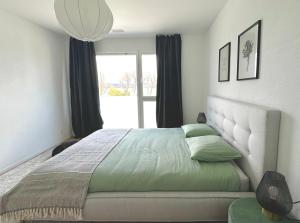 En eller flere senger på et rom på Stylisches Ferienhaus bis 6 Gäste mit einzigartigem Seepanorama