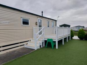 a house with a porch and stairs next to it at 205 Holiday Resort Unity Pet friendly pass includ in Brean