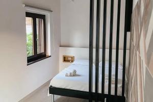 a bedroom with a bed with a black crib at Resort Petrasia in Villammare +64 photos