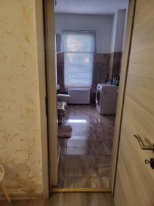 an open door to a room with a bathroom at 3 Apartments Angels o k b in Altenburg +18 photos