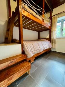 a bedroom with two bunk beds and a window at Stone Maisonettes in Aigio