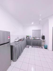 a kitchen with a table and a screen in a room at Aidee Homestay Taman Ria Height in Tawau