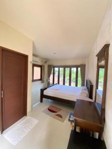 a bedroom with a bed and a desk and window at Game Bar in Surat Thani