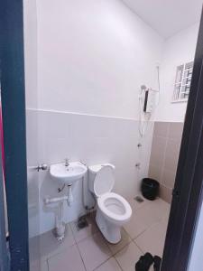 a bathroom with a toilet and a sink at Aidee Homestay Taman Ria Height in Tawau