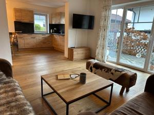 a living room with a couch and a coffee table at Chalet Bergglück in Piesendorf