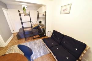 a living room with a couch and a table at Cosy Studio - Private Entrance Bishop’s Stortford in Bishops Stortford