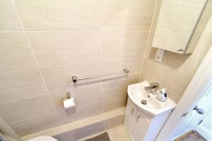 a bathroom with a toilet and a sink at Cosy Studio - Private Entrance Bishop’s Stortford in Bishops Stortford