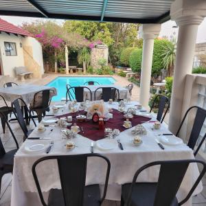 a table set up for a meal on a patio at Xaviera Guest House in Pretoria