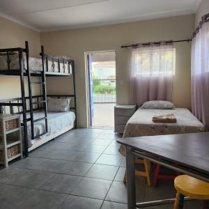 a bedroom with two bunk beds and a table at Xaviera Guest House in Pretoria