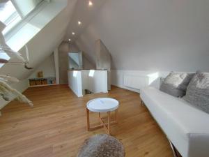 a living room with a white couch and a table at Ferienwohnung Schmidt in Schüttorf