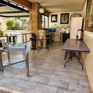 a room with wooden floors and tables and a kitchen at Xaviera Guest House in Pretoria