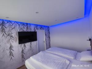 a bedroom with a bed and a wall with a tv at Apartment Feldkirch in Feldkirch