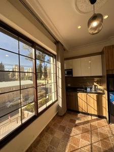 a kitchen with a large window in a house at 5/ Antica jabalal-lwebdeh in Amman