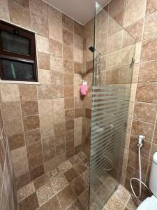 a bathroom with a shower with a glass door at 5/ Antica jabalal-lwebdeh in Amman