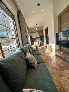 a living room with a couch and a television at 5/ Antica jabalal-lwebdeh in Amman +27 photos