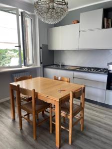 a kitchen with a wooden table and two chairs at La casa in collina in Caprino Veronese