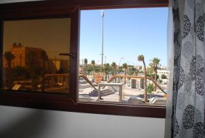 a window in a room with a view of a patio at Apartamentos Bchraya in Laayoune