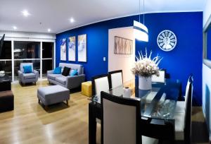 a living room with a blue wall and a dining room at GL Apts, rent Upper Pardo Miraflores - Suite 1 Hab in Lima +64 photos