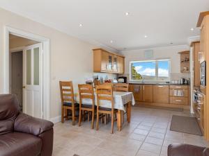 a kitchen and dining room with a table and chairs at Highgrove in Narberth