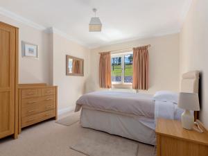 a bedroom with a bed and a window at Highgrove in Narberth