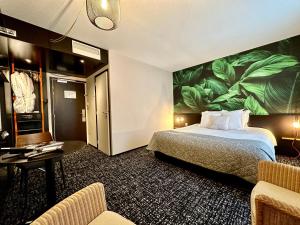 a hotel room with a bed and a large mural at La Paix Hôtel Contemporain Brest centre ville in Brest